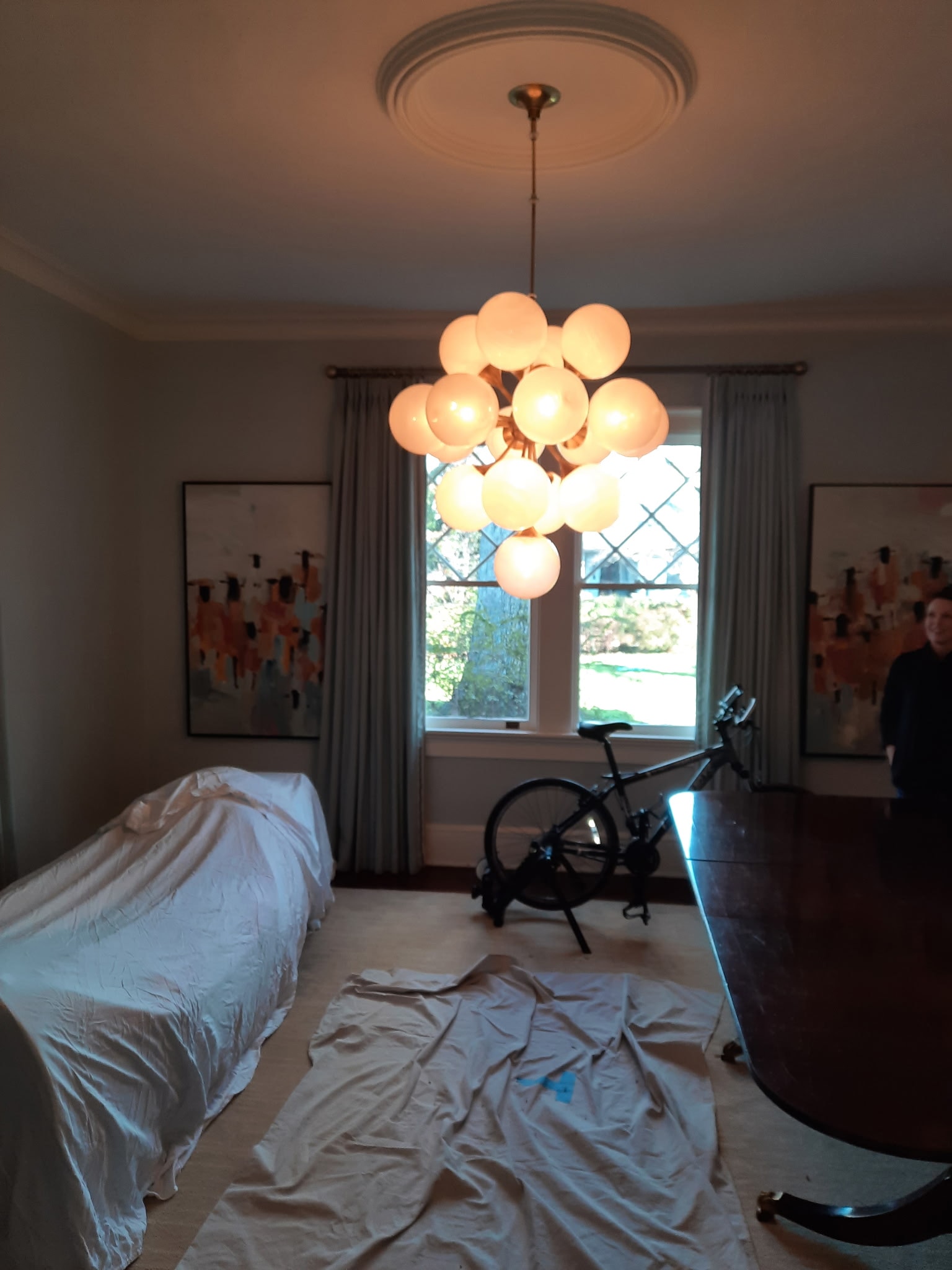 Modern globe chandelier installation in a residential interior