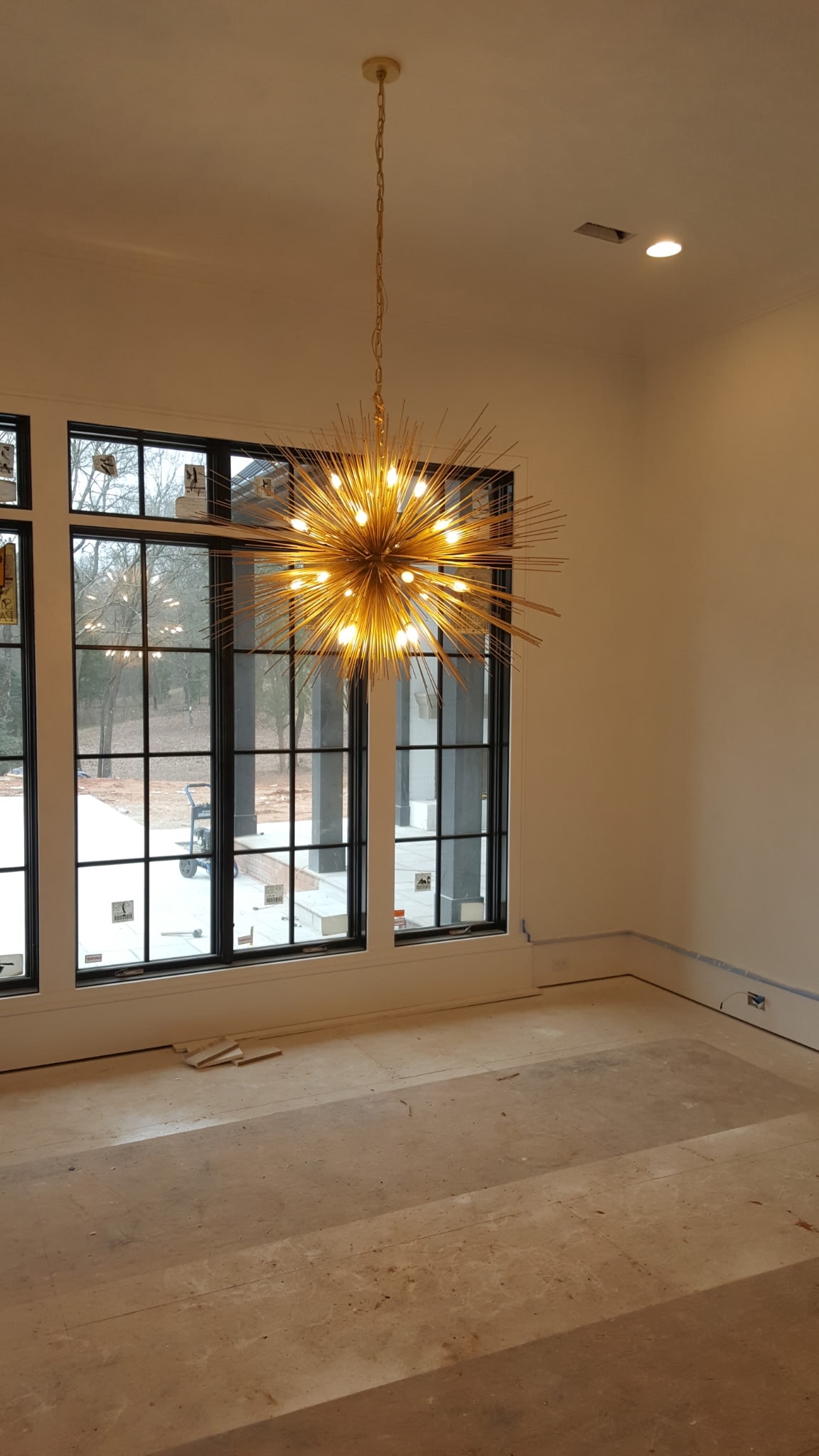 Starburst chandelier installation in a newly constructed home